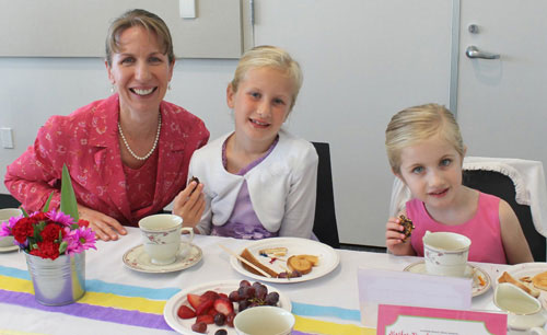 Ladies Sip Tea with Pinky Fingers Down at Etiquette Party